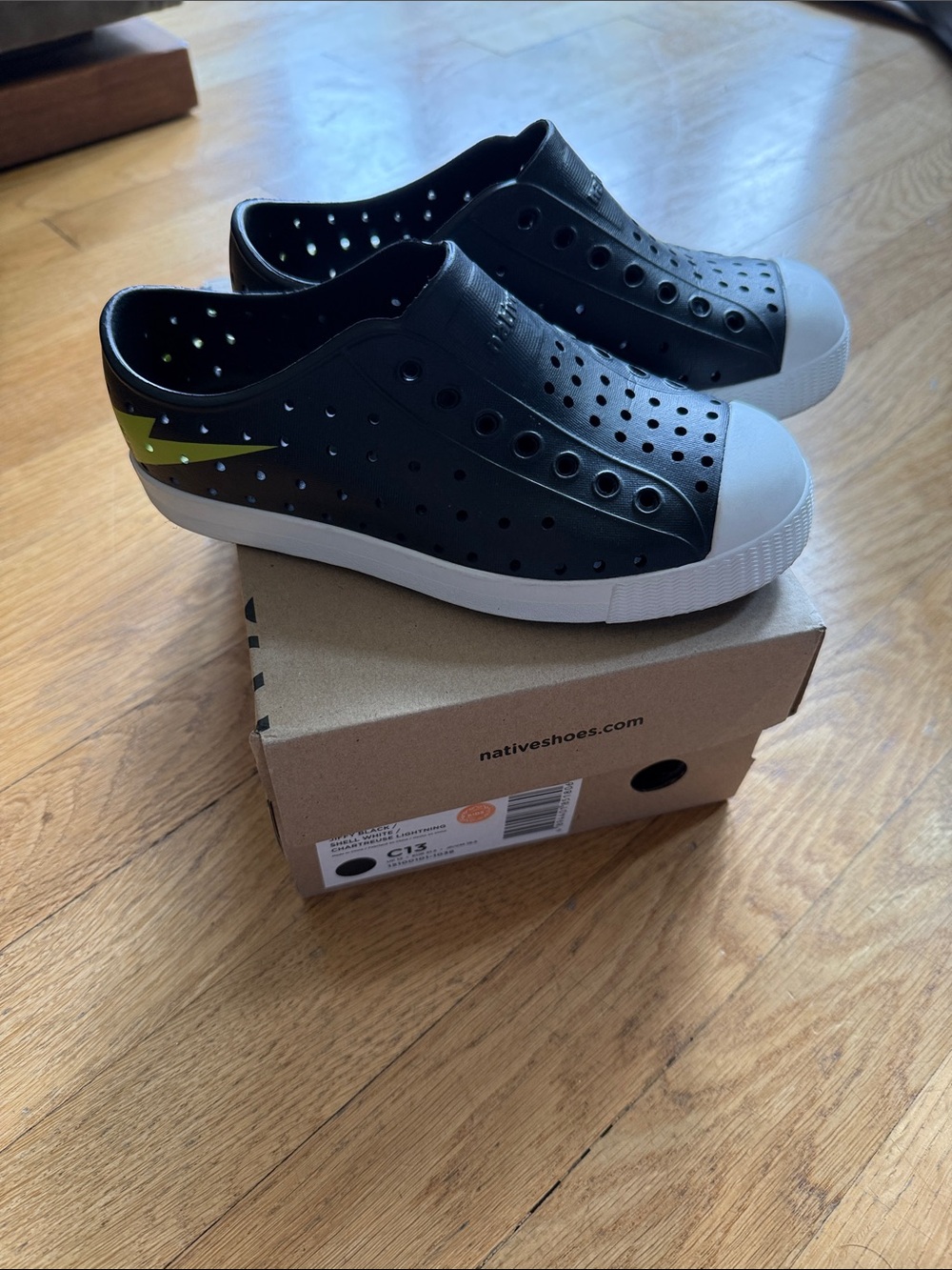 Native Black Slip-On Sneakers with Neon Lightning Bolt Accent